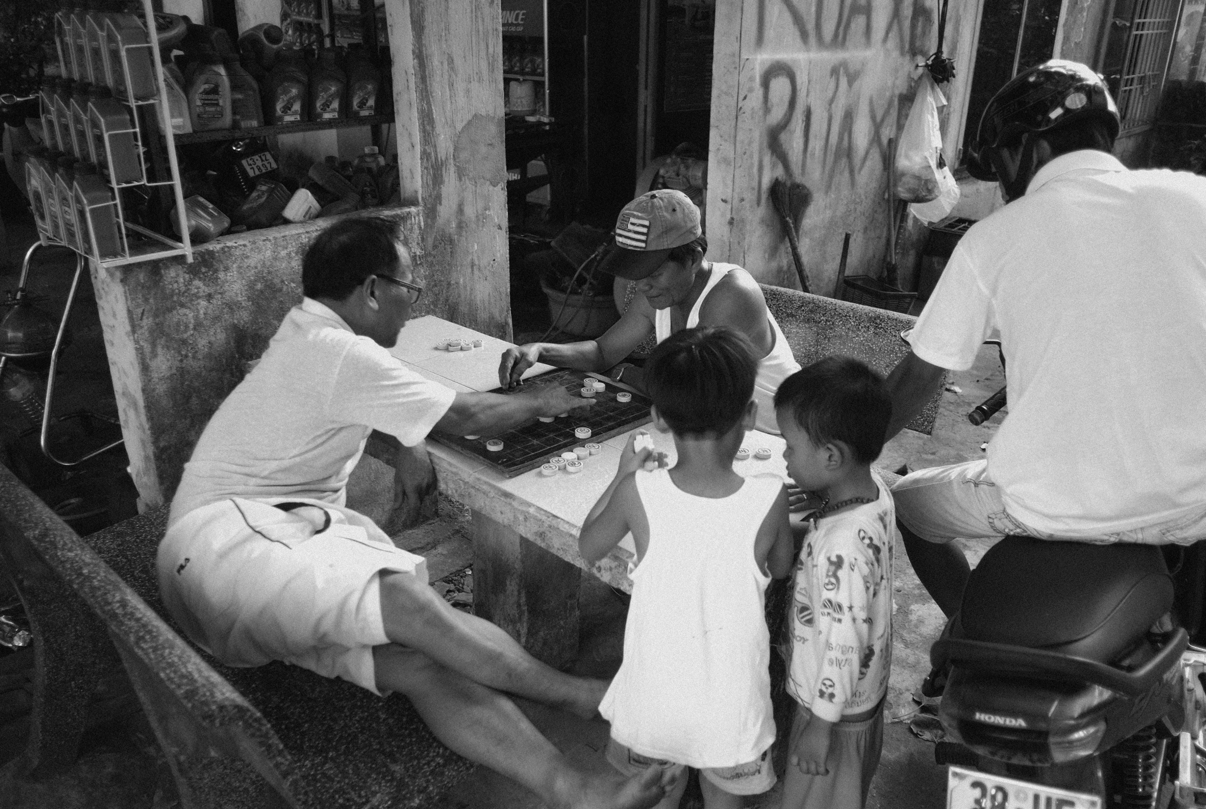 a man with two small children and one is sitting