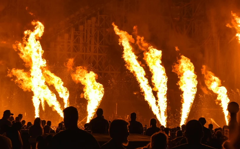 large fire is glowing orange as people watch