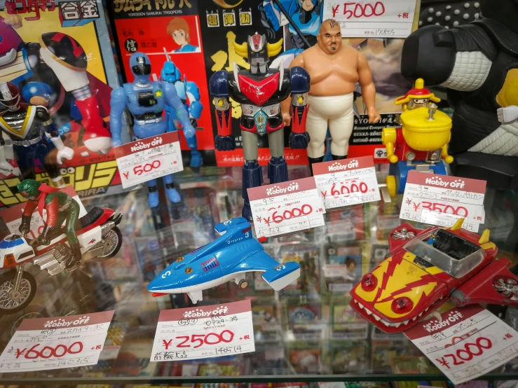 various toy figures and sales signs on display