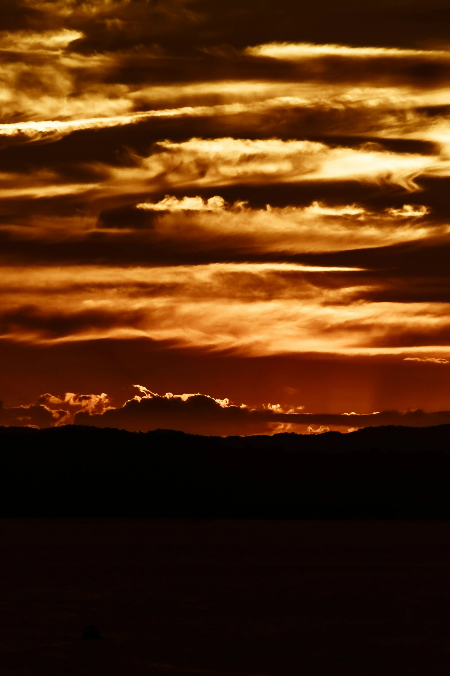 an orange and red sunset is on the horizon