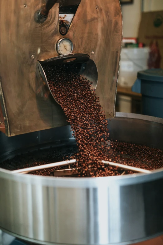 there is a coffee grinder that has coffee being poured out