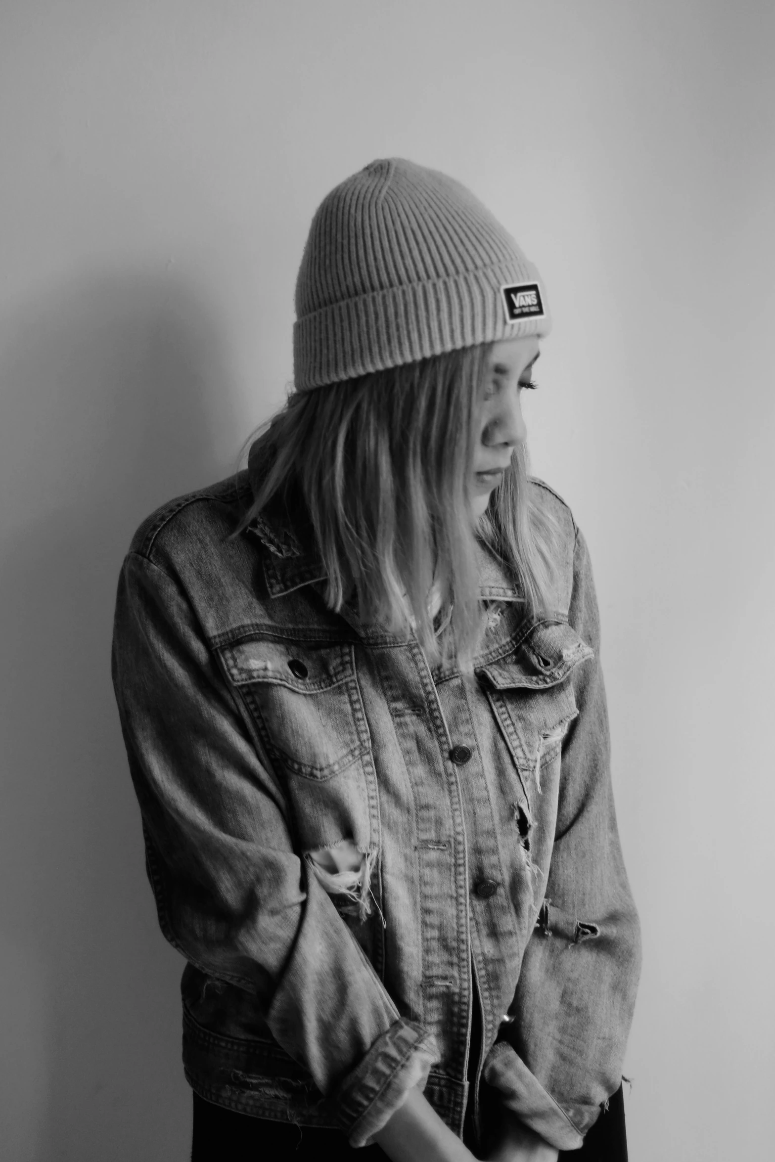 a young woman in a beanie hat smiles while posing