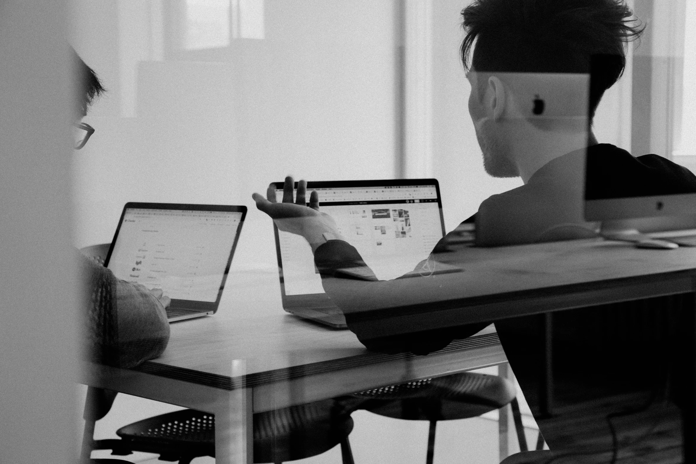 a man sitting at a desk using a computer