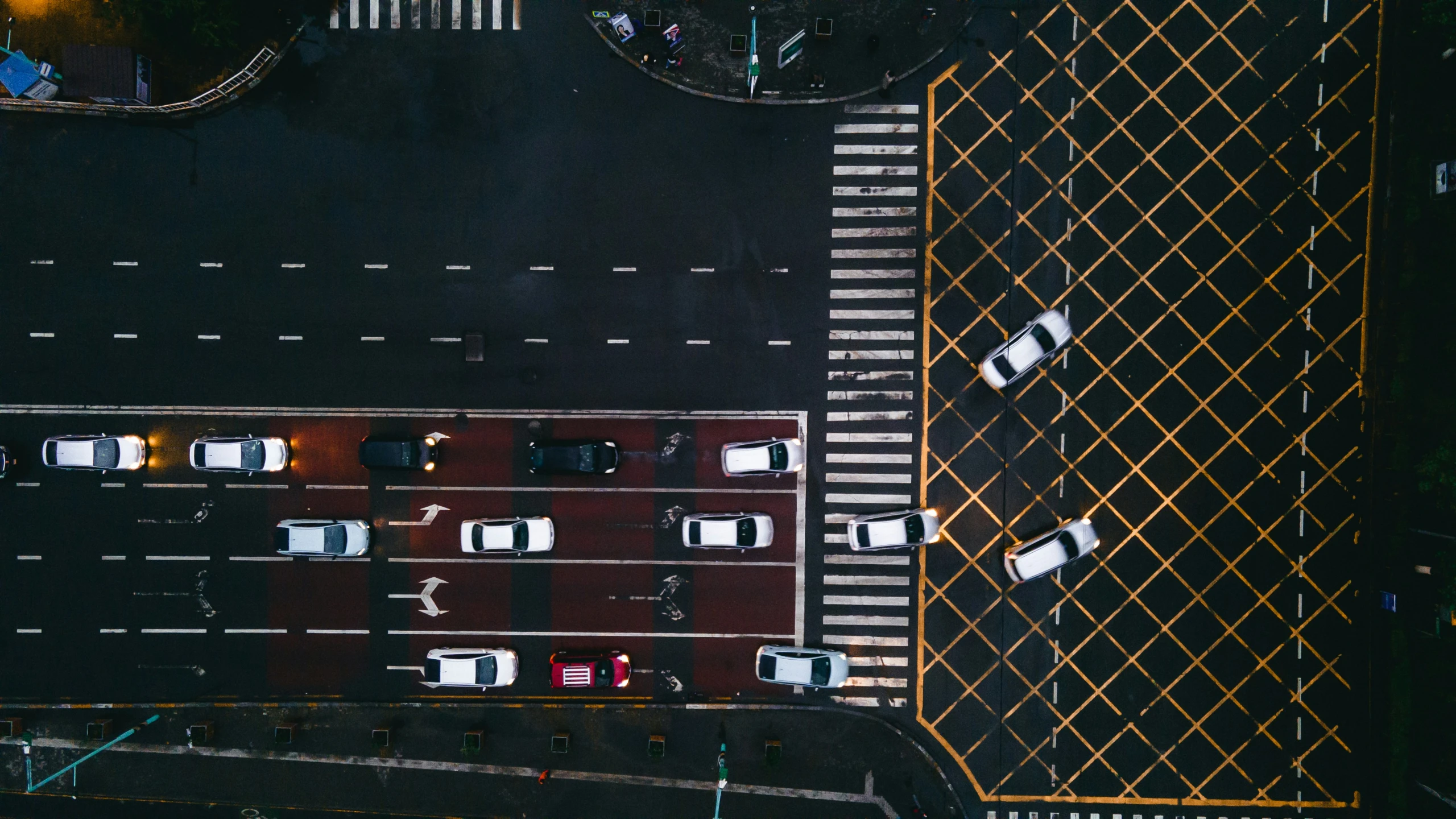 an aerial view of a street intersection with cars at night