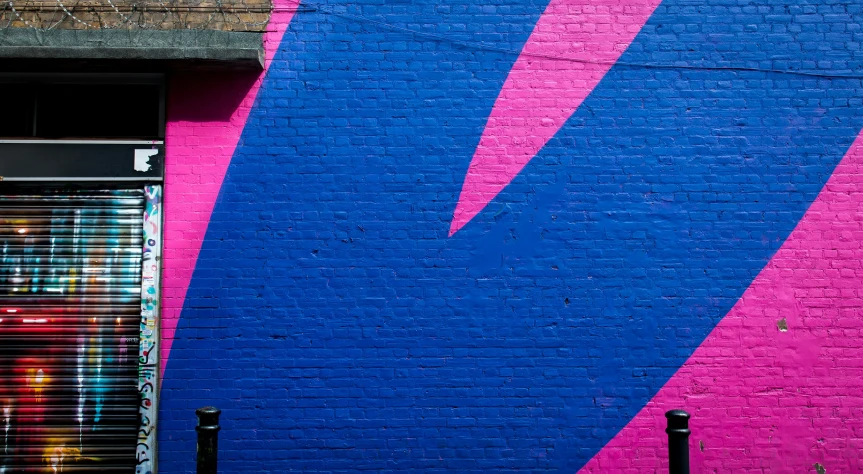 a brick wall has a graffiti painted on it