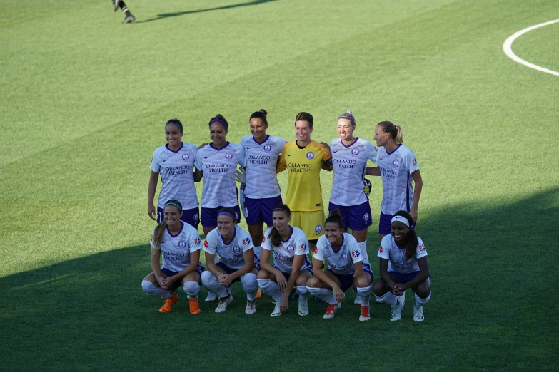 a soccer team poses for a picture in their uniform