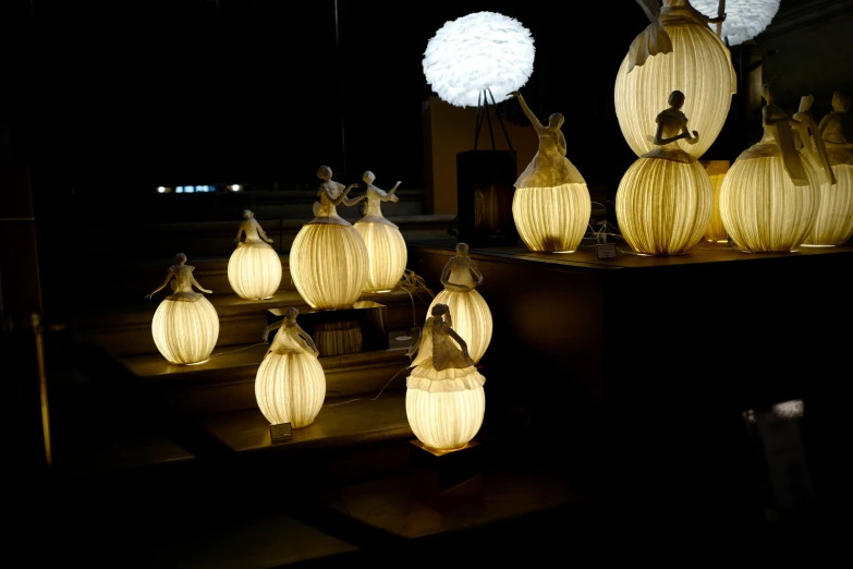 several round shaped lights on display in front of a black background