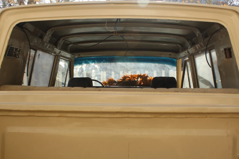 looking through the windshield of a tan vehicle