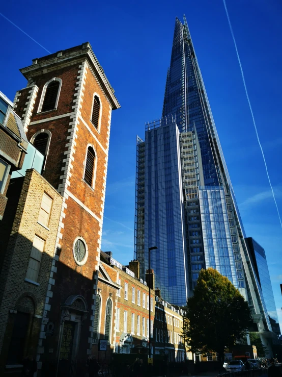 a street next to tall buildings on a sunny day