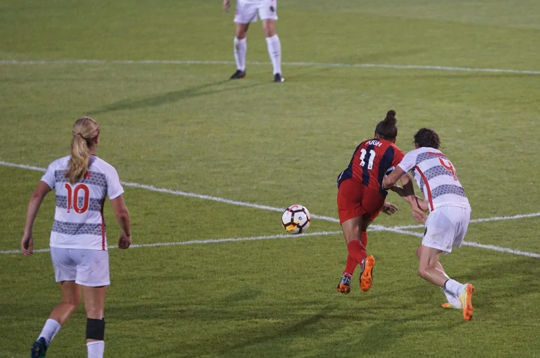 a group of players fight over a soccer ball