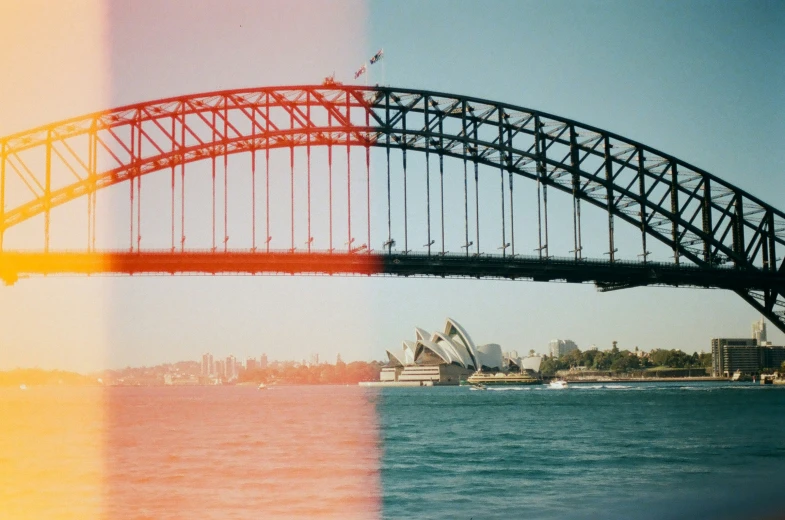 a long bridge spans over water with the city in the background