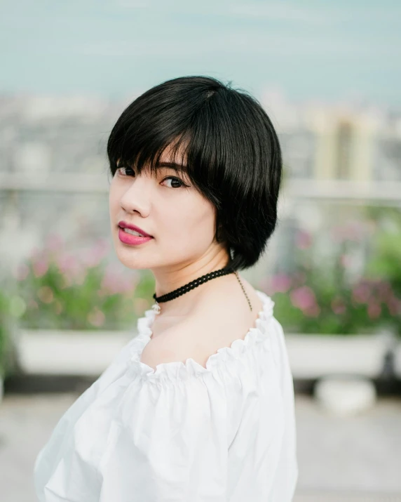 a woman with short hair and an elegant necktie posing for a picture