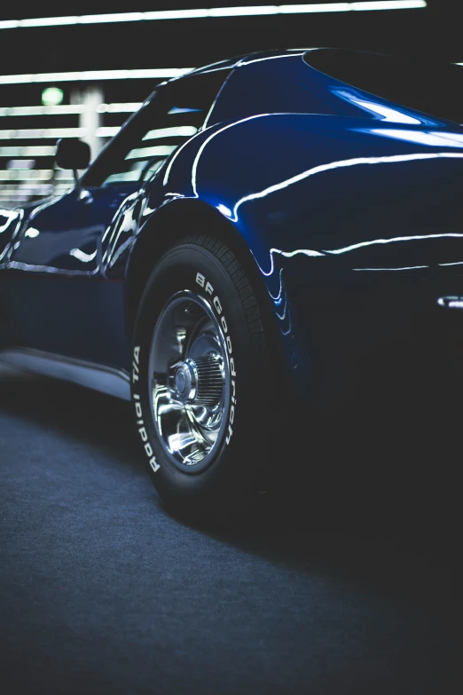 a black car parked inside of a garage