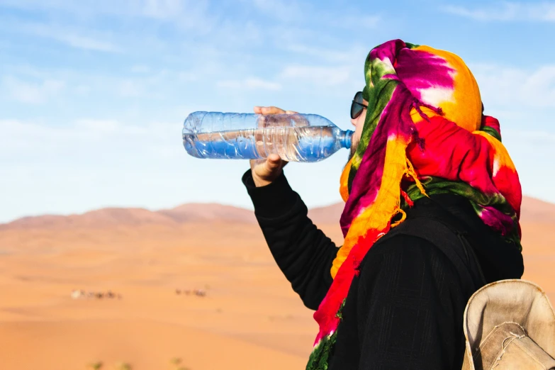 a women who is drinking from a water bottle