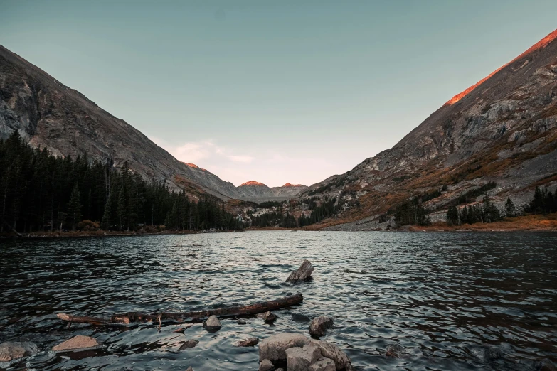 a beautiful view of mountains sitting behind a lake