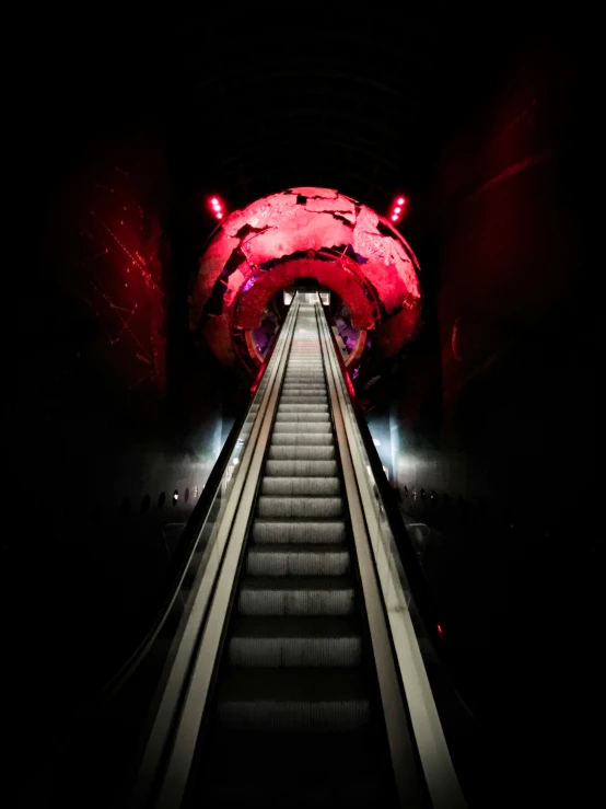 an escalator in an underground tunnel for passengers to ride up or down