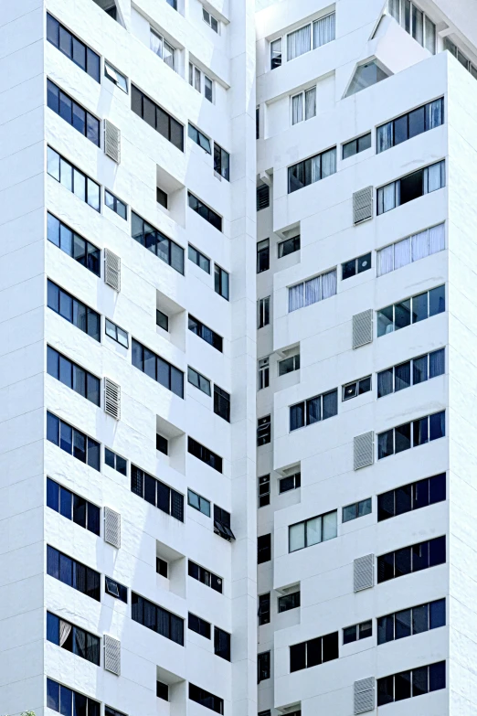 two tall white buildings on a city street