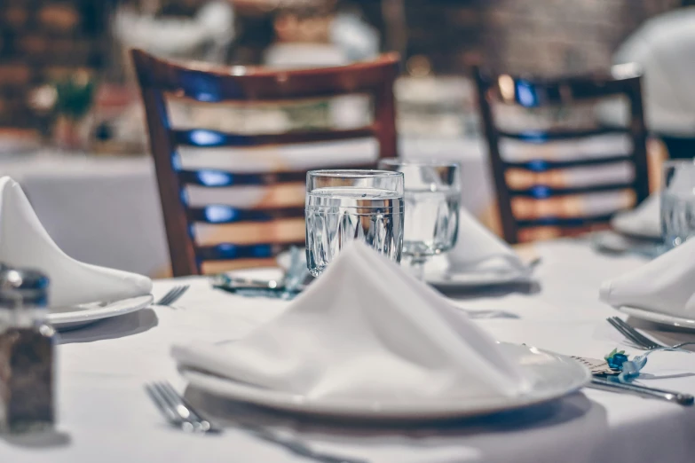 a table that has a white plate and silverware