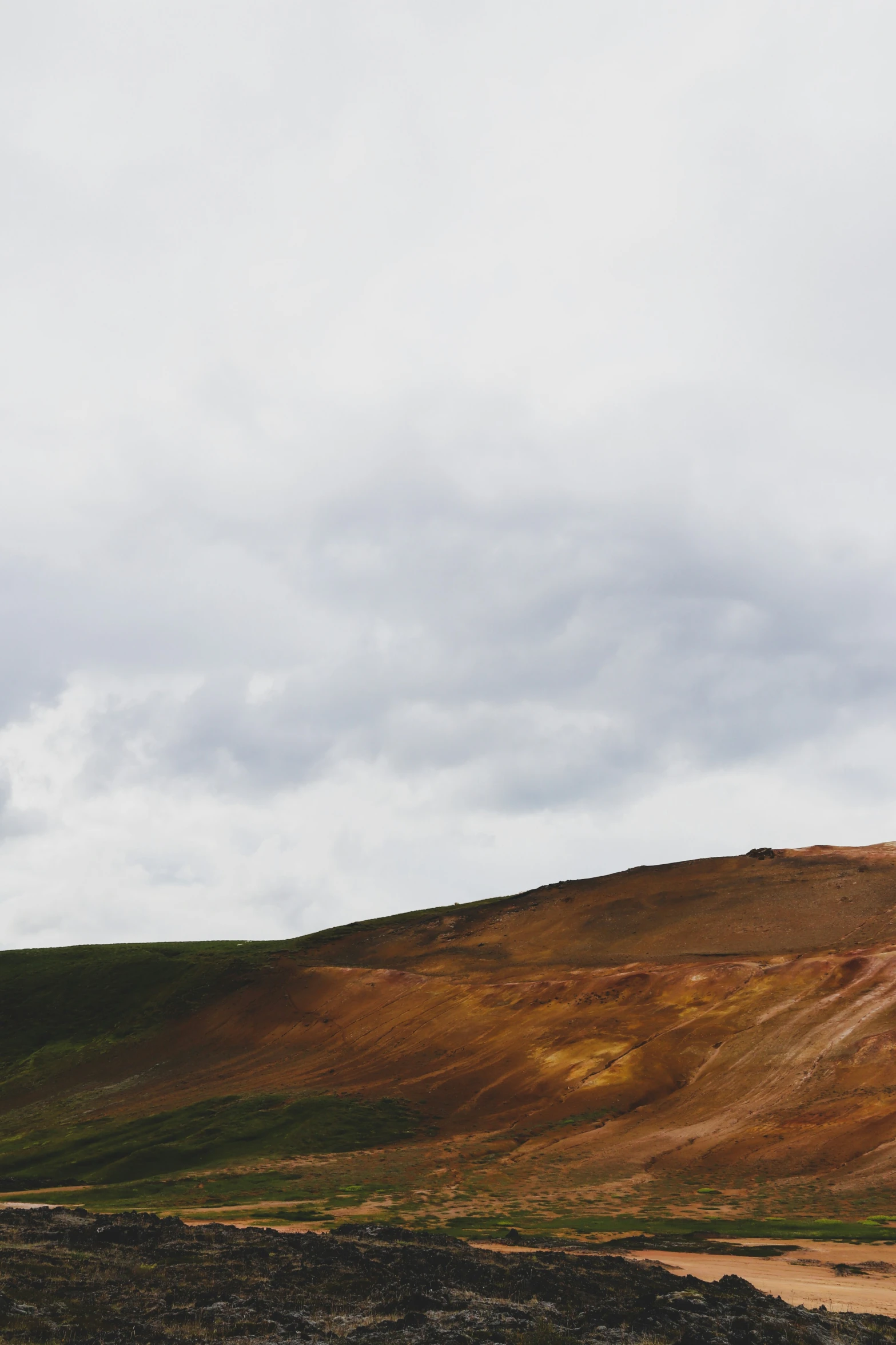 a hill in the middle of an empty field