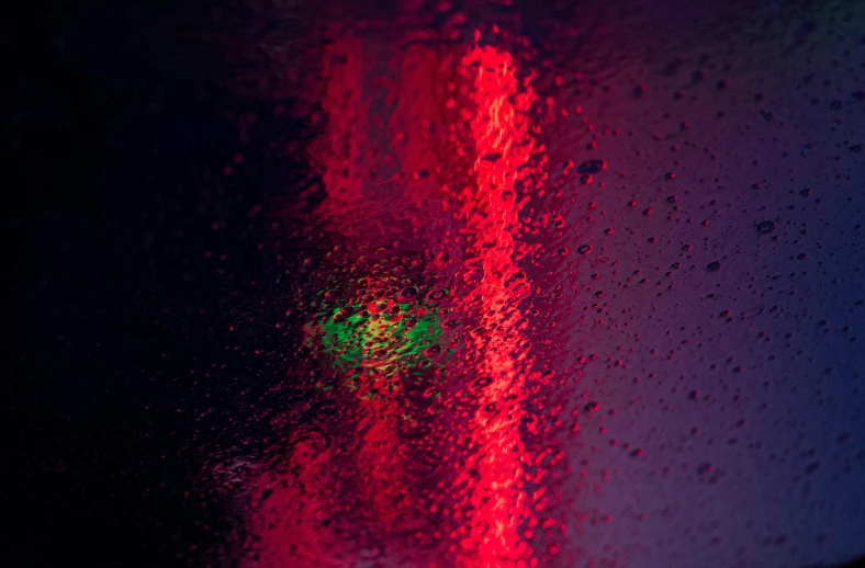 the view through a wet window showing a street sign