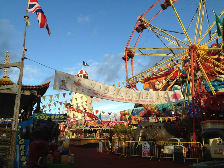 a carnival ride with flags flying in the wind