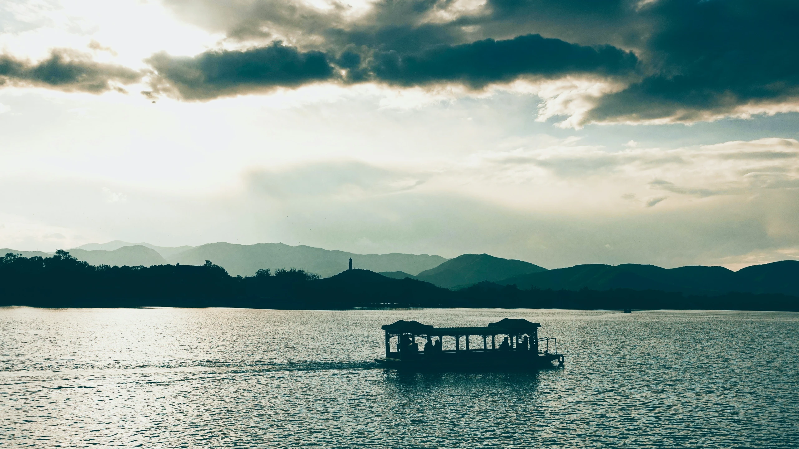 a boat with animals on the deck moves through a body of water