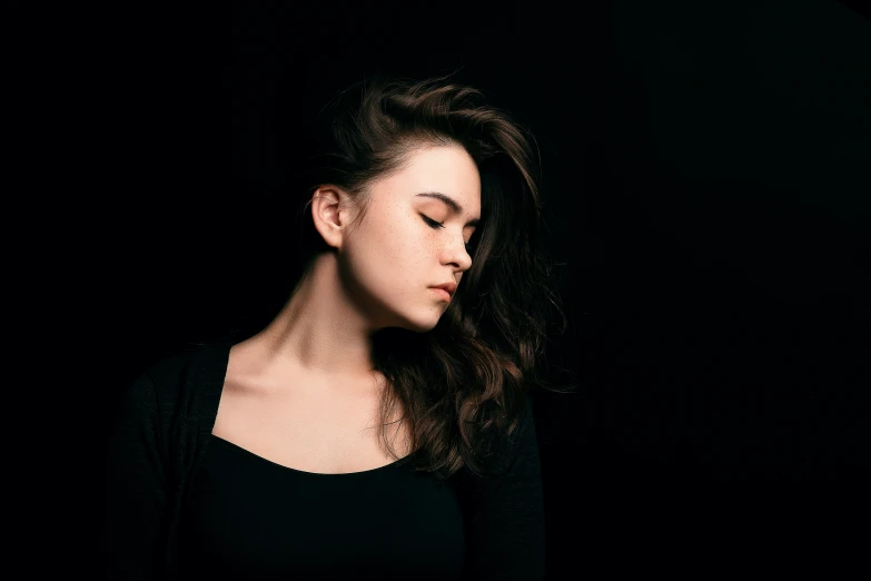 woman wearing black shirt with black background