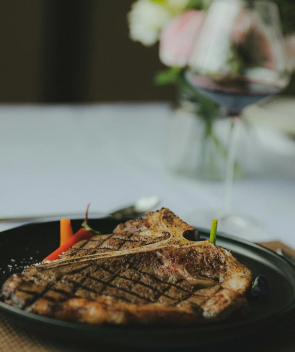 a plate with steak and vegetables is on a table