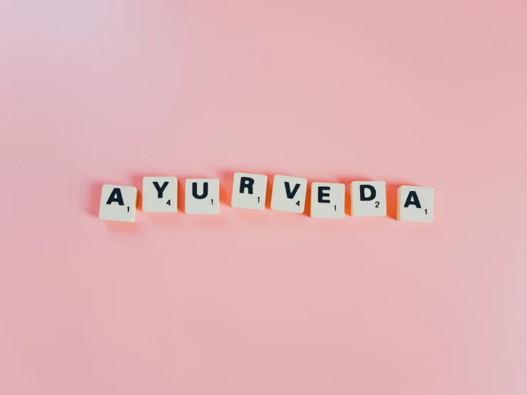 blocks spelling the words ayuruda over a pink background
