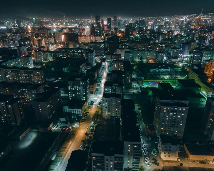 a city from a tall building lit up at night