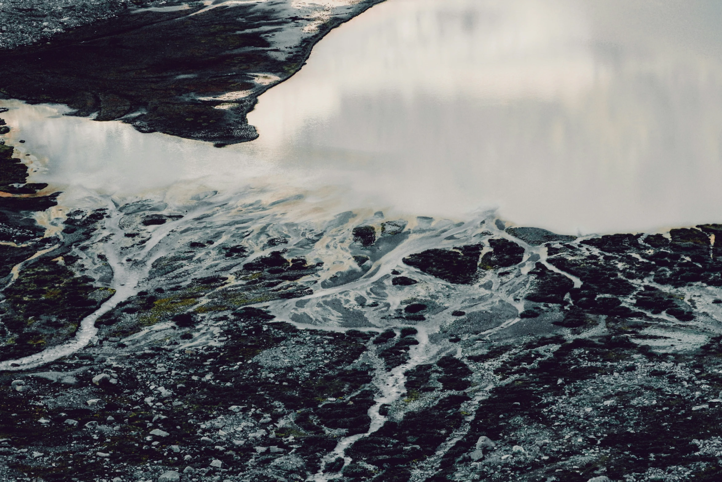 a water pool in a lake with ice on the ground