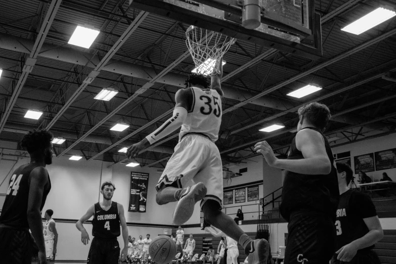 a person that is jumping in the air with a basketball