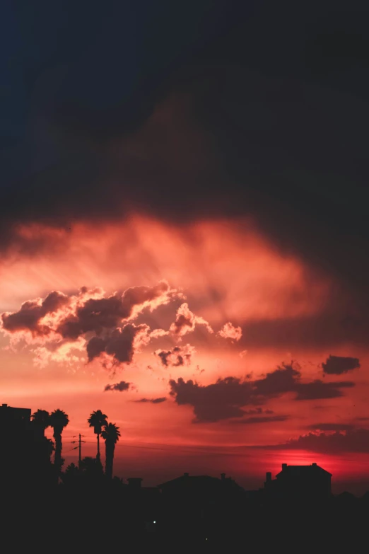 a view of a sun setting over some houses