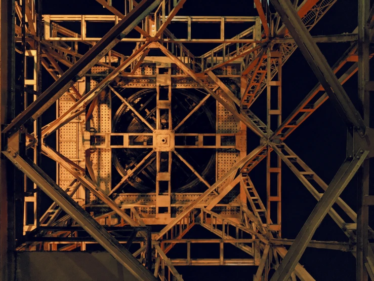 some steel bars are suspended from the side of an old bridge