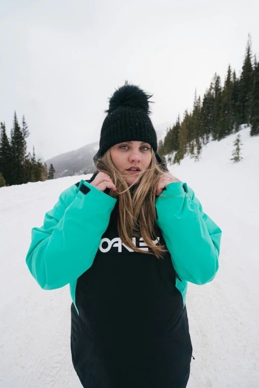 a young woman poses on a snowy slope