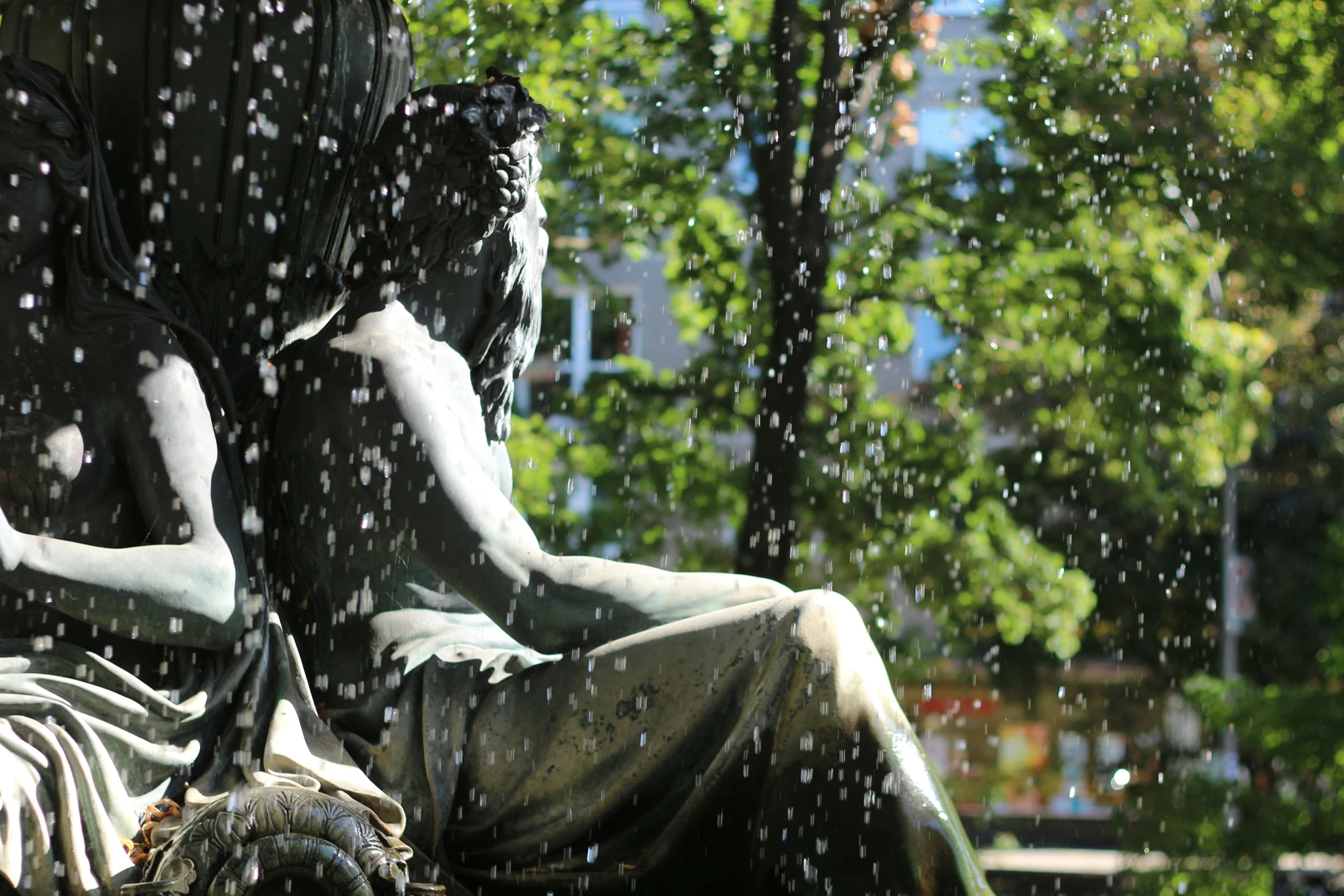 a statue is surrounded by rain and water