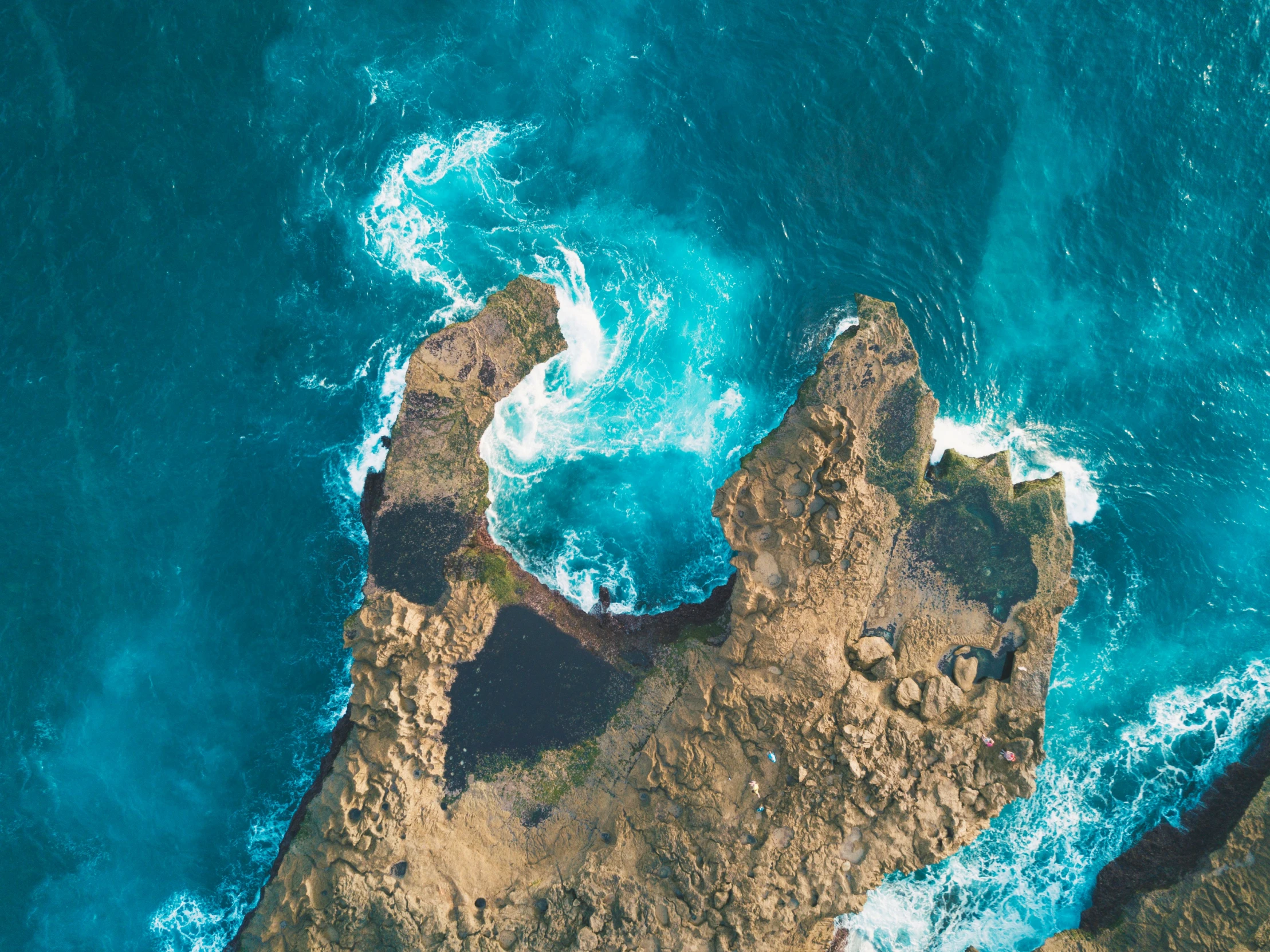 an aerial s of the sea waves and land