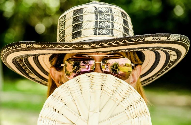 the woman is posing with her hat on her head