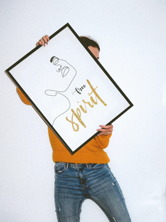 a person holding up a poster in front of their face