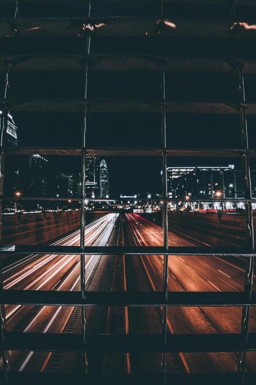 car lights streak through the night city skyline