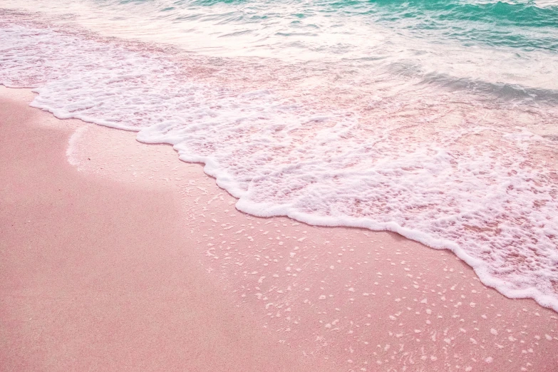 an empty beach has waves lapping toward the shore