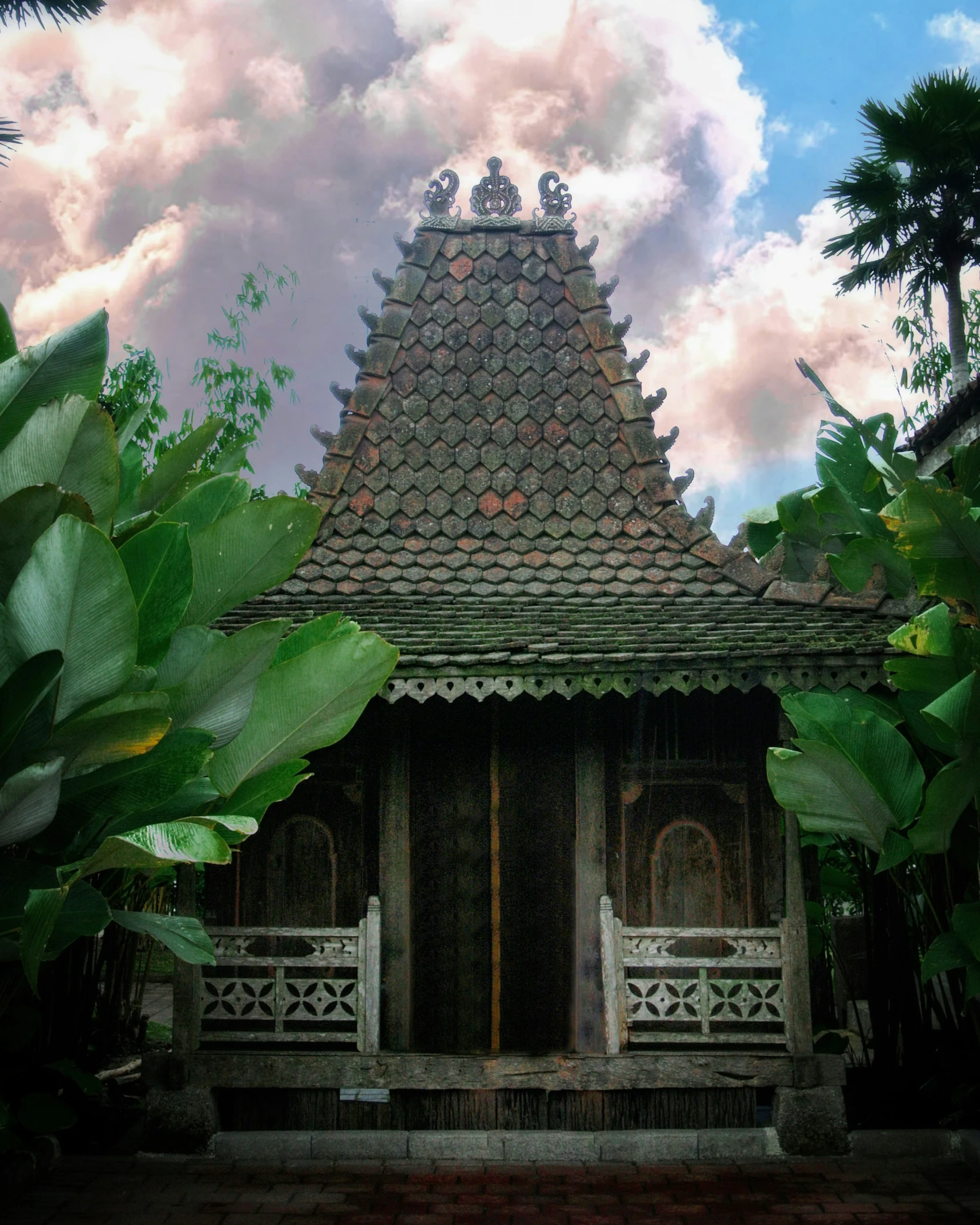 a wooden structure with a gate between it and trees