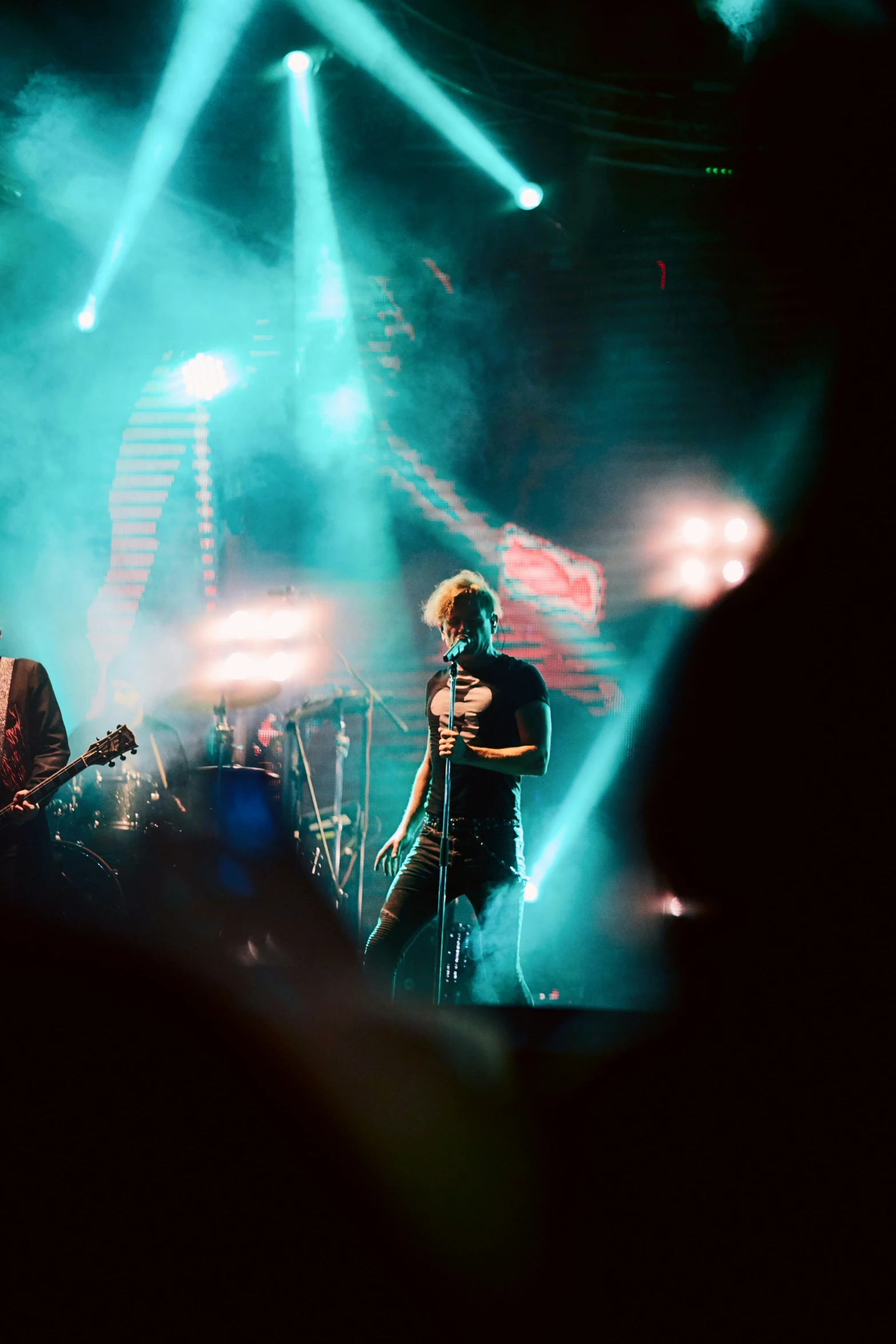 people on stage performing in the dark