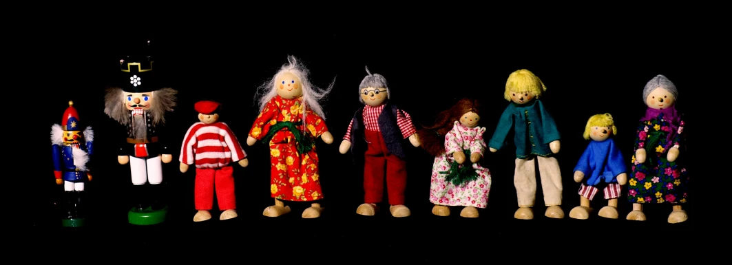 dolls of different ages and clothes are shown in a row