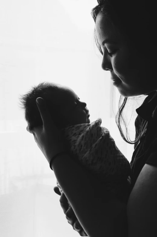 a woman holding a baby in her arms