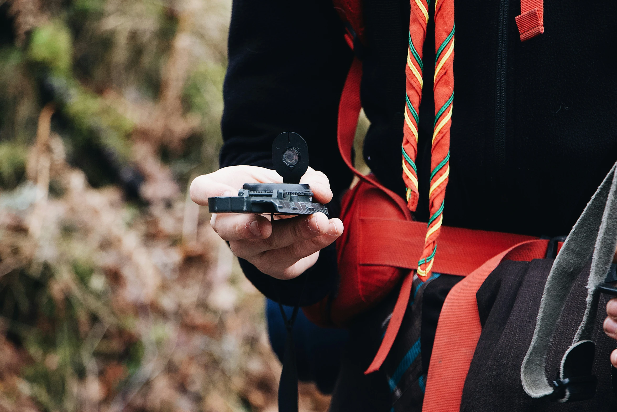 the person with a red tie is holding a knife and cell phone