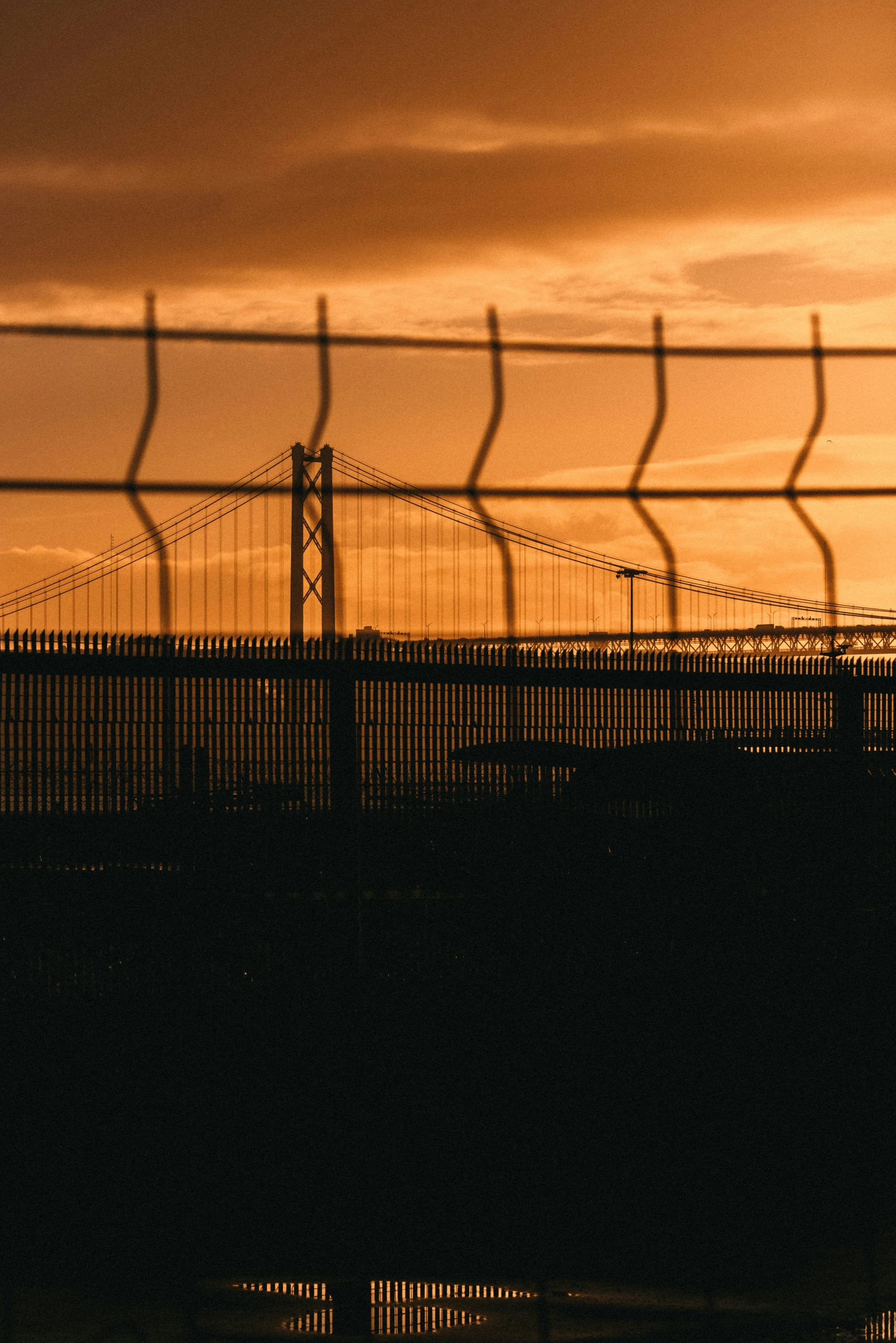 a very long bridge with a fence on the side