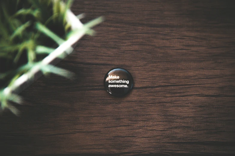 an empty black round on sitting on a wooden surface