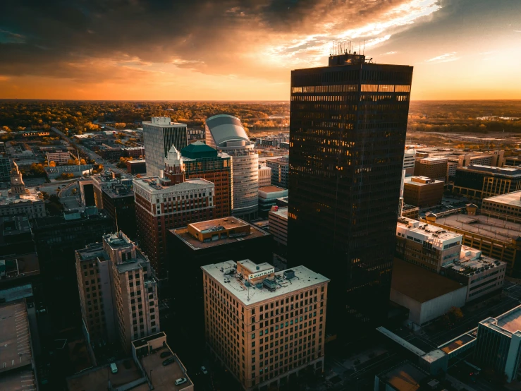 a view of a city at sunset with skyscrs and sky