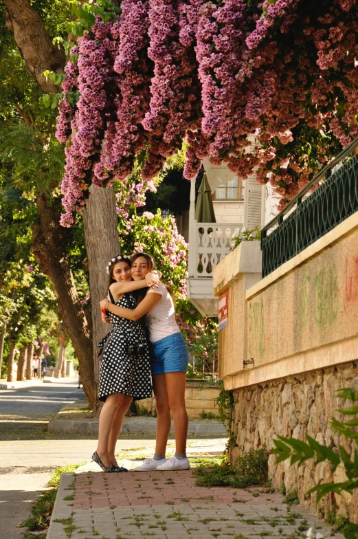 two women hugging and standing next to each other